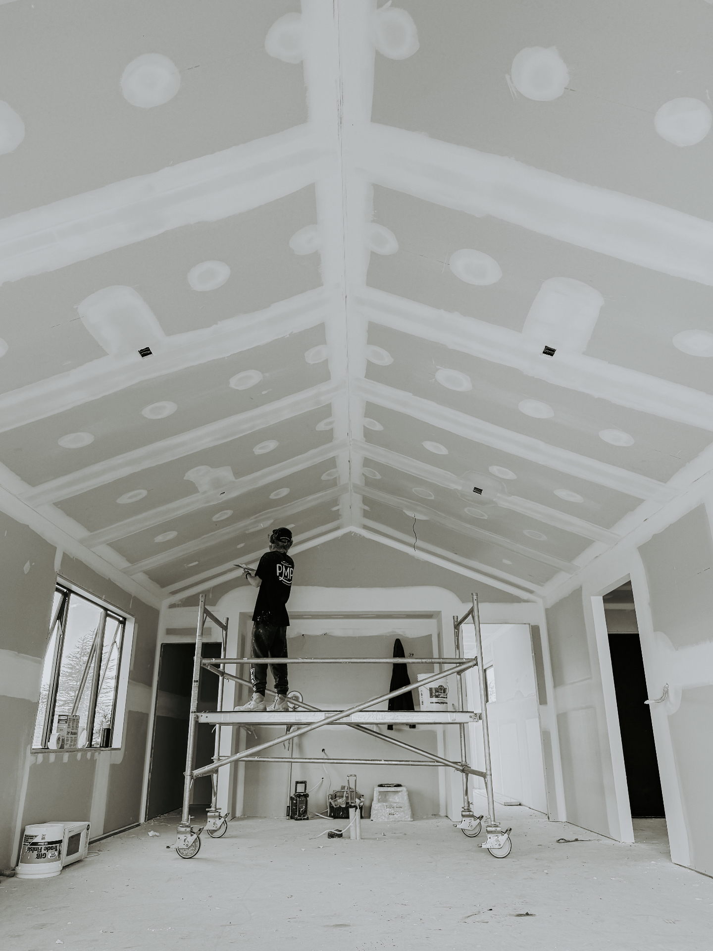 PMP plasterer on scaffolding working a high ceiling